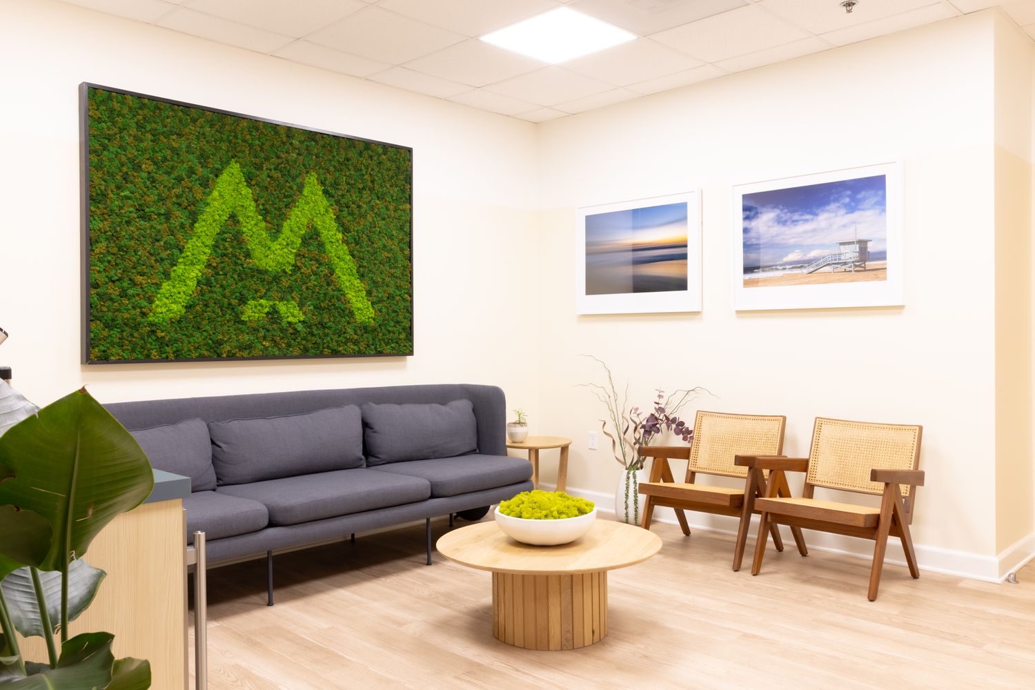 Modern waiting room with green wall art.