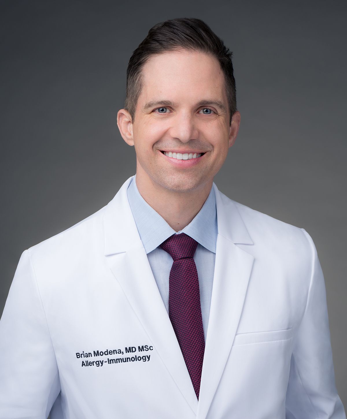 Portrait of doctor in white coat smiling