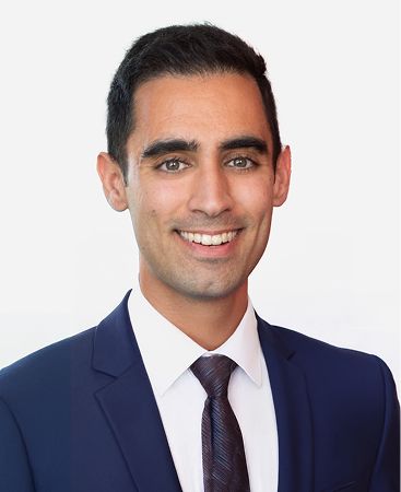 Smiling man in a suit on a white background.