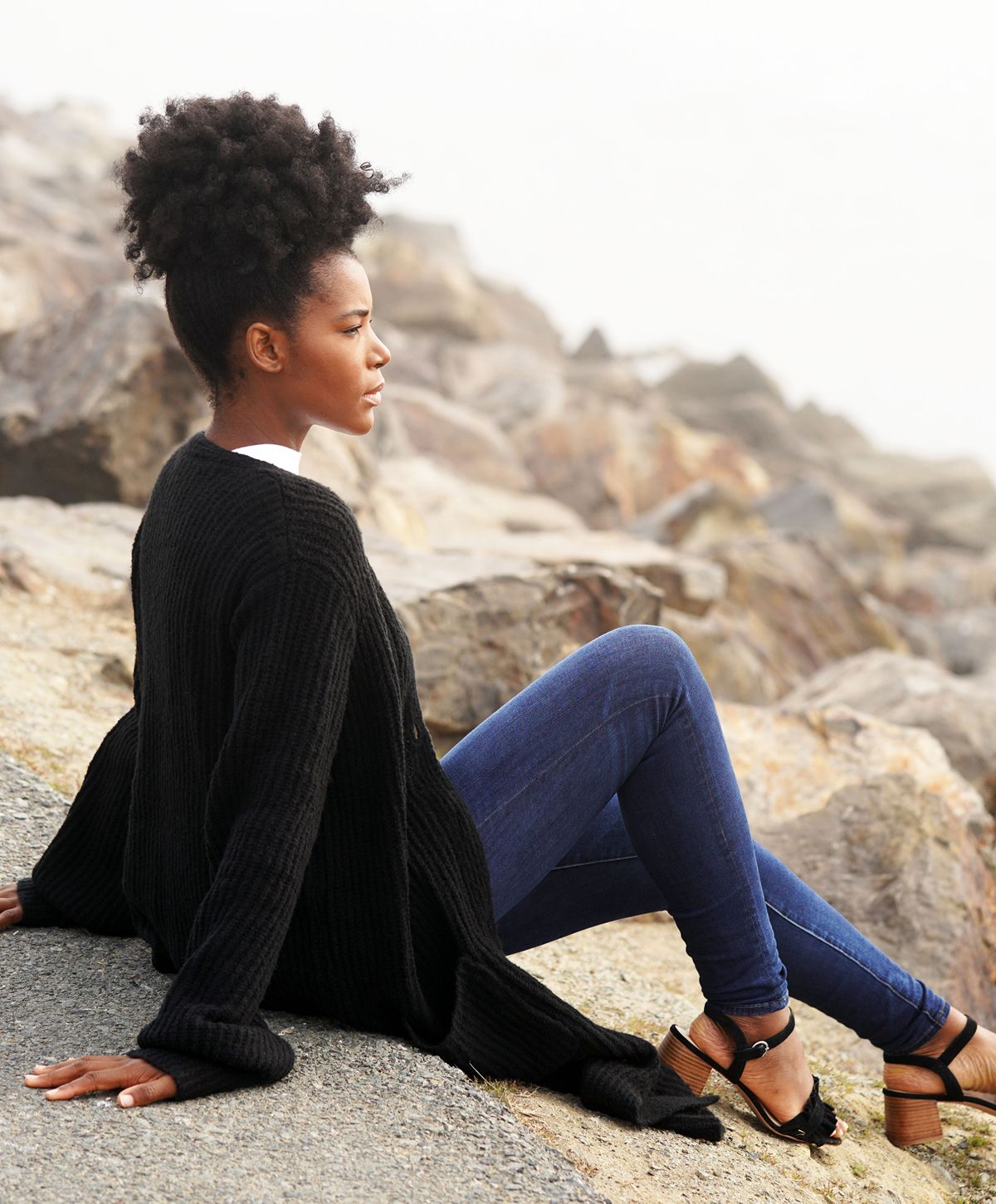 Woman in a floral dress among sunflowers.