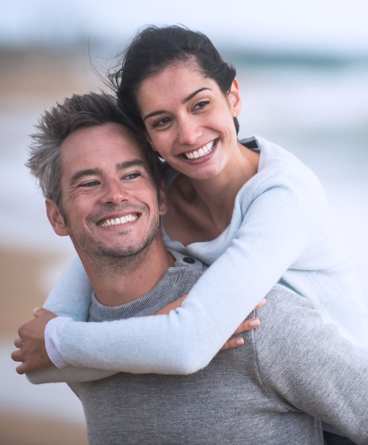 Happy couple enjoying a beach moment together.