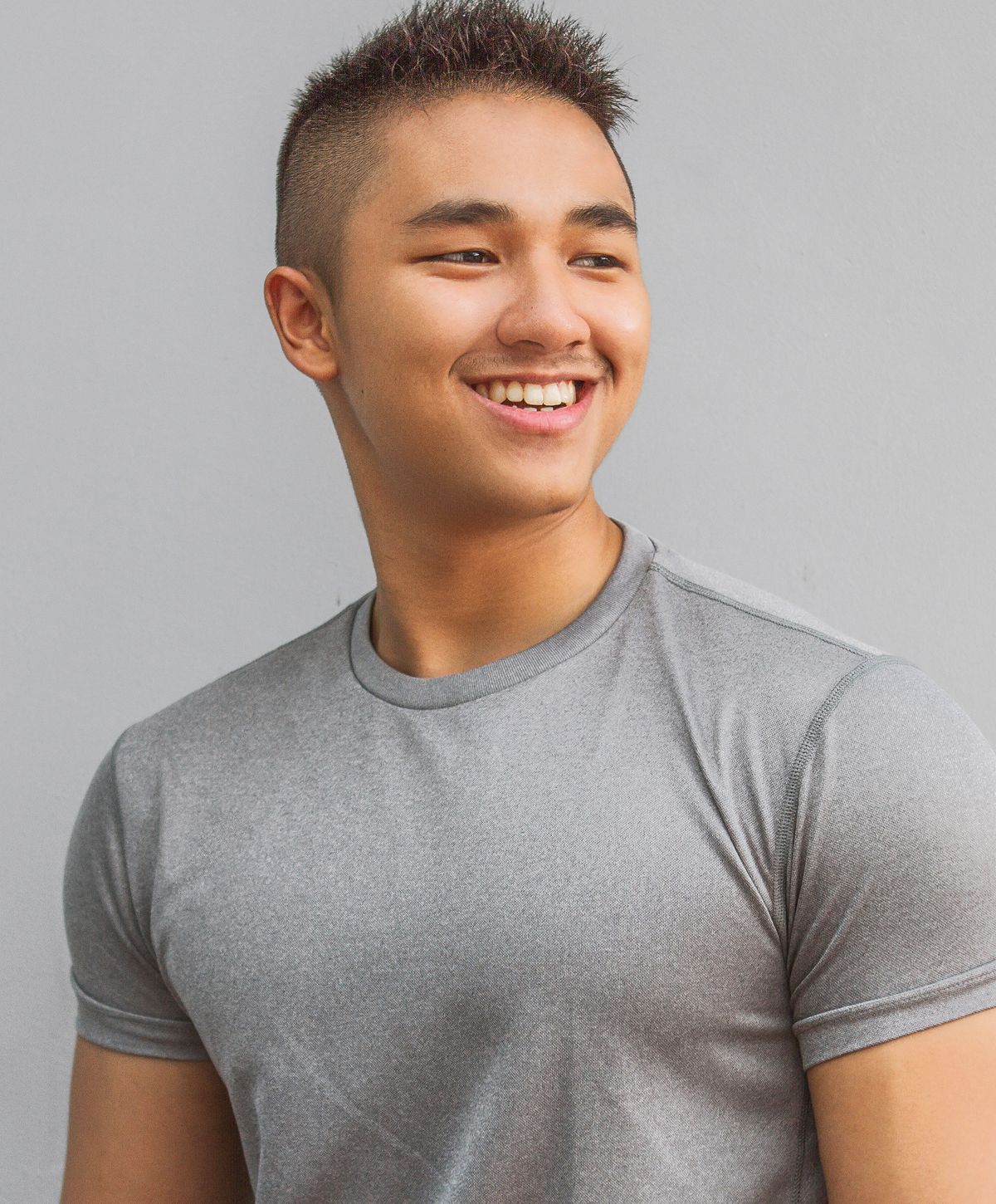 Smiling man jogging outdoors on sunny day