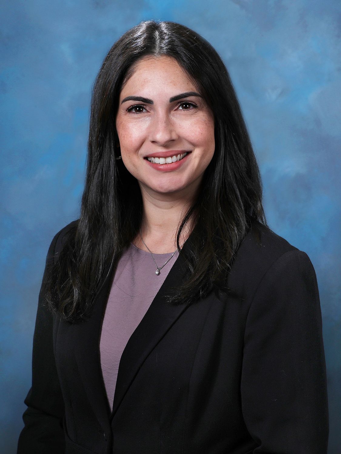 Professional portrait of a woman in business attire.