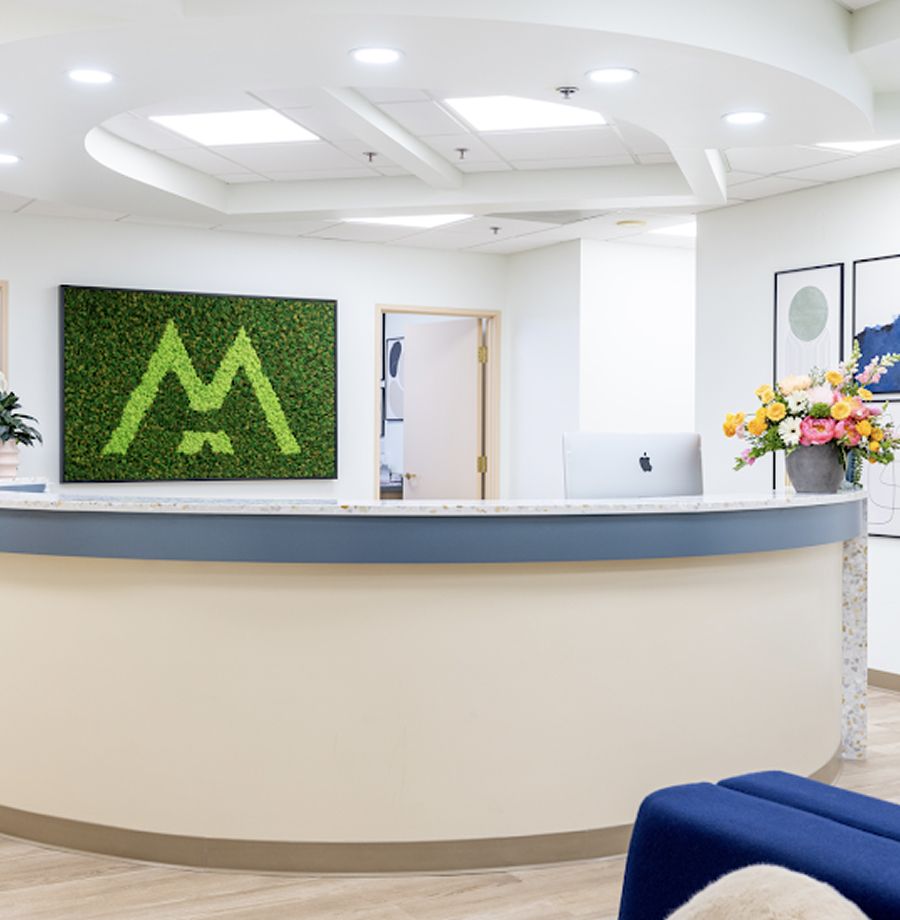 Modern reception area with decorative green wall.
