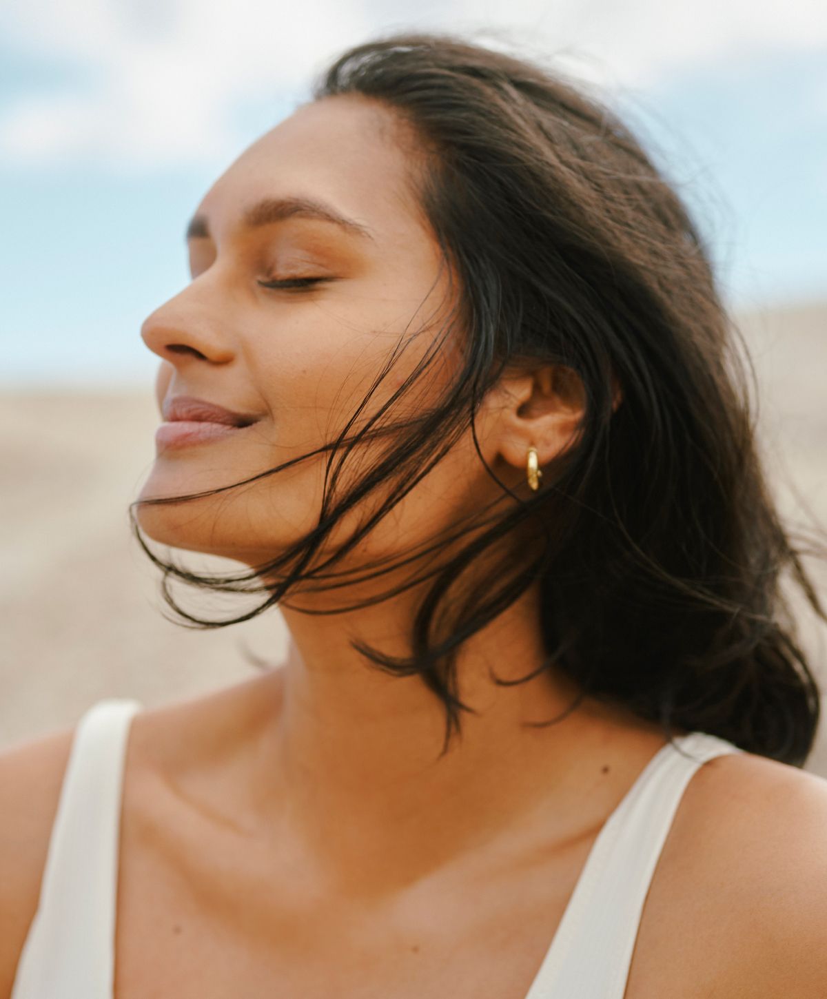 Woman with closed eyes enjoying a breeze.