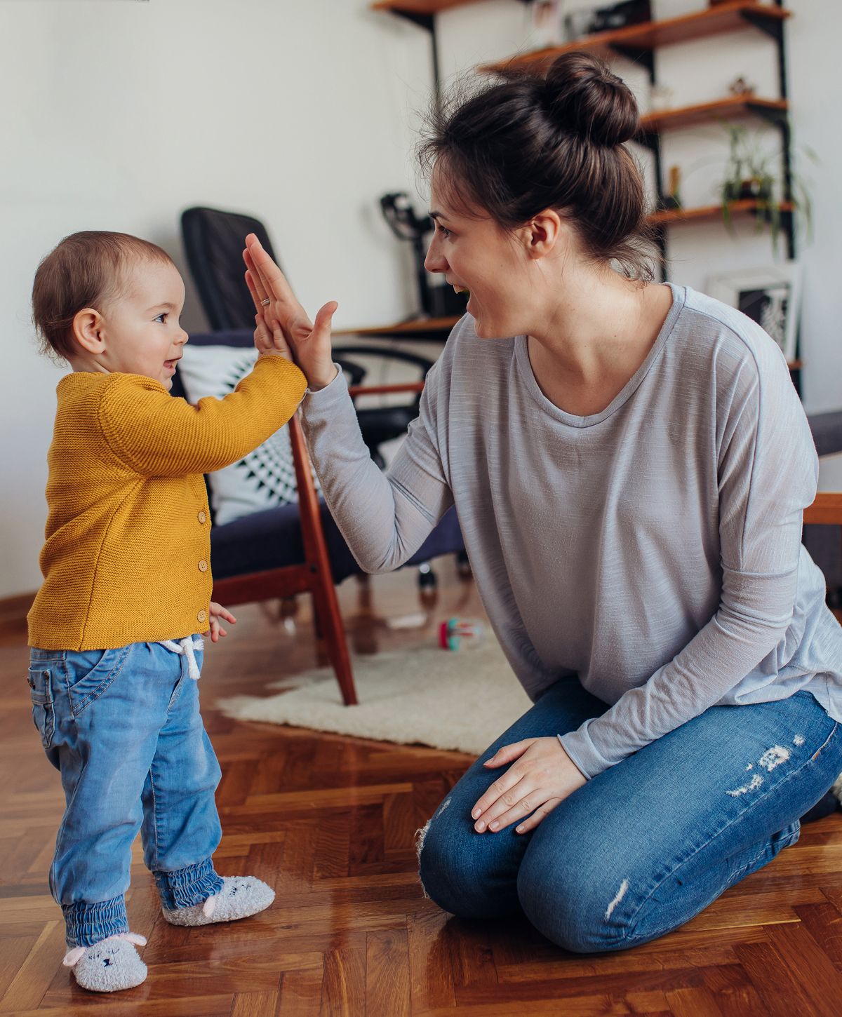 Mother and child sharing a cheerful high-five.