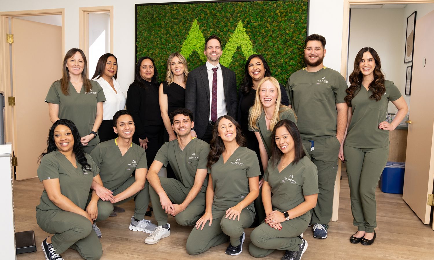 Team photo of medical professionals smiling together.