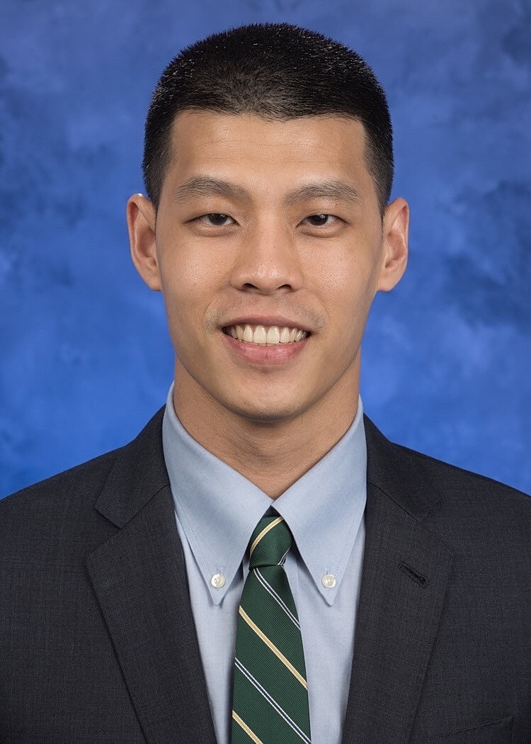 Professional headshot of a man in suit.