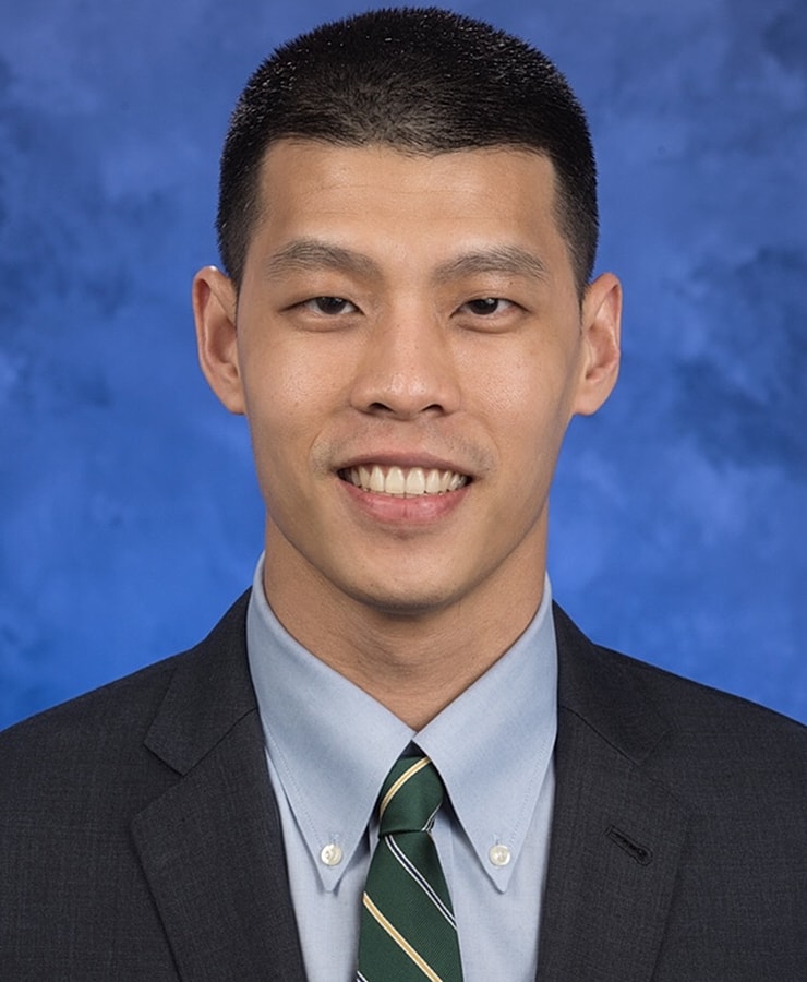 Professional headshot of a smiling man.
