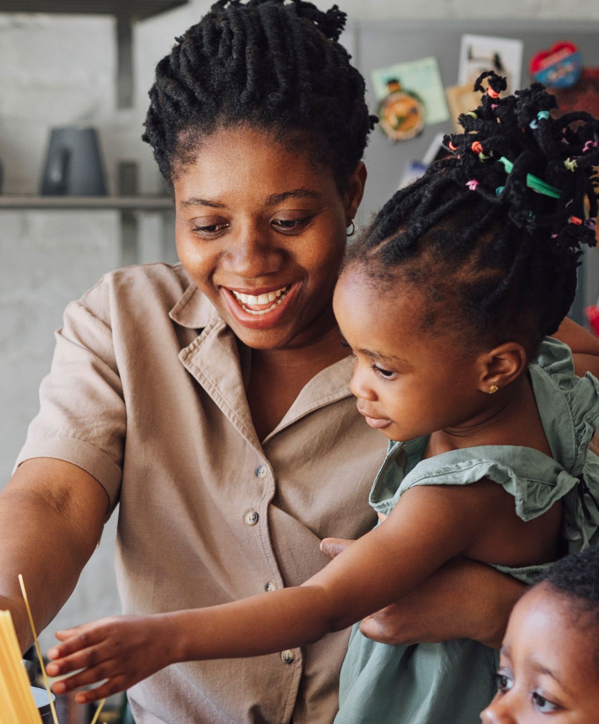 Happy mother interacting with young children.