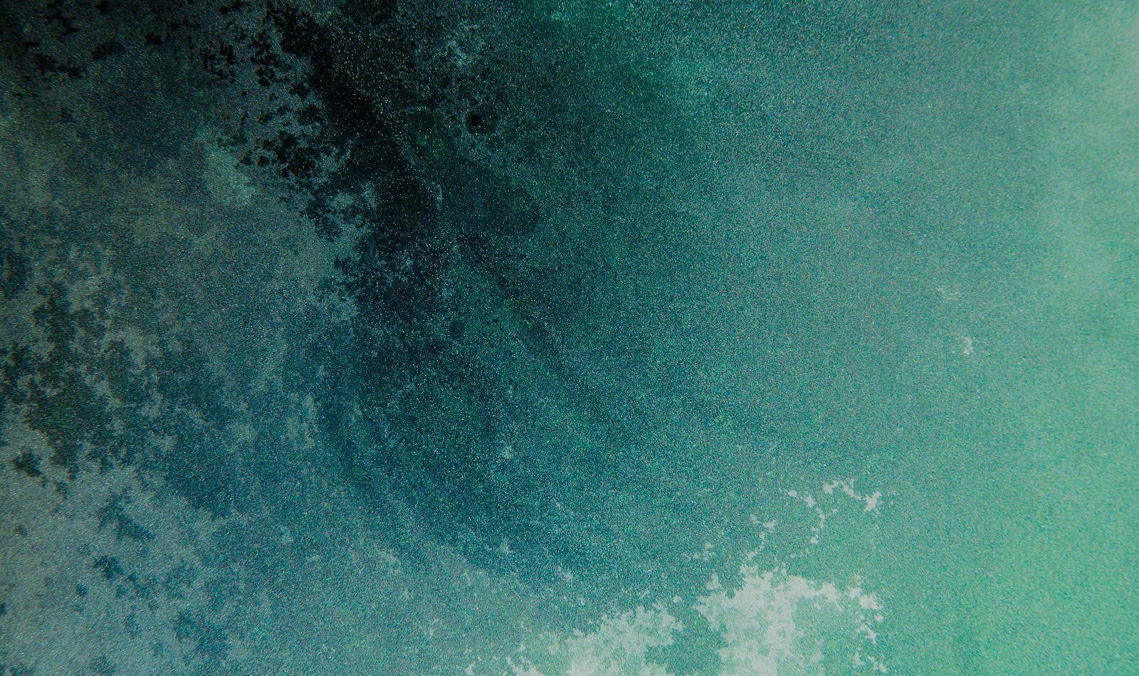 Abstract teal and blue textured background image.