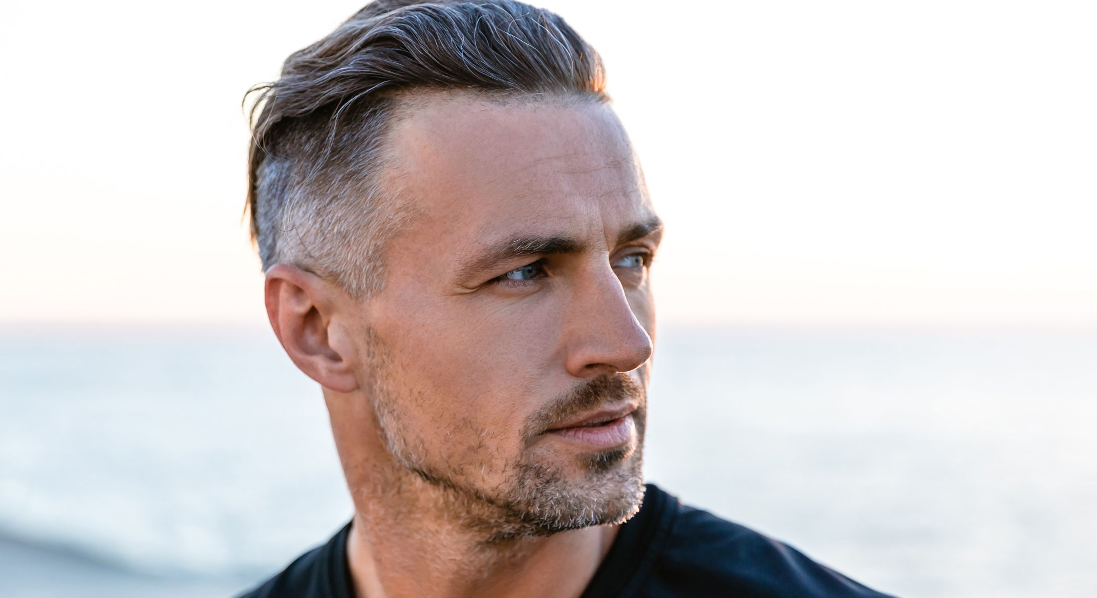 Man with stylish hair by the seaside.