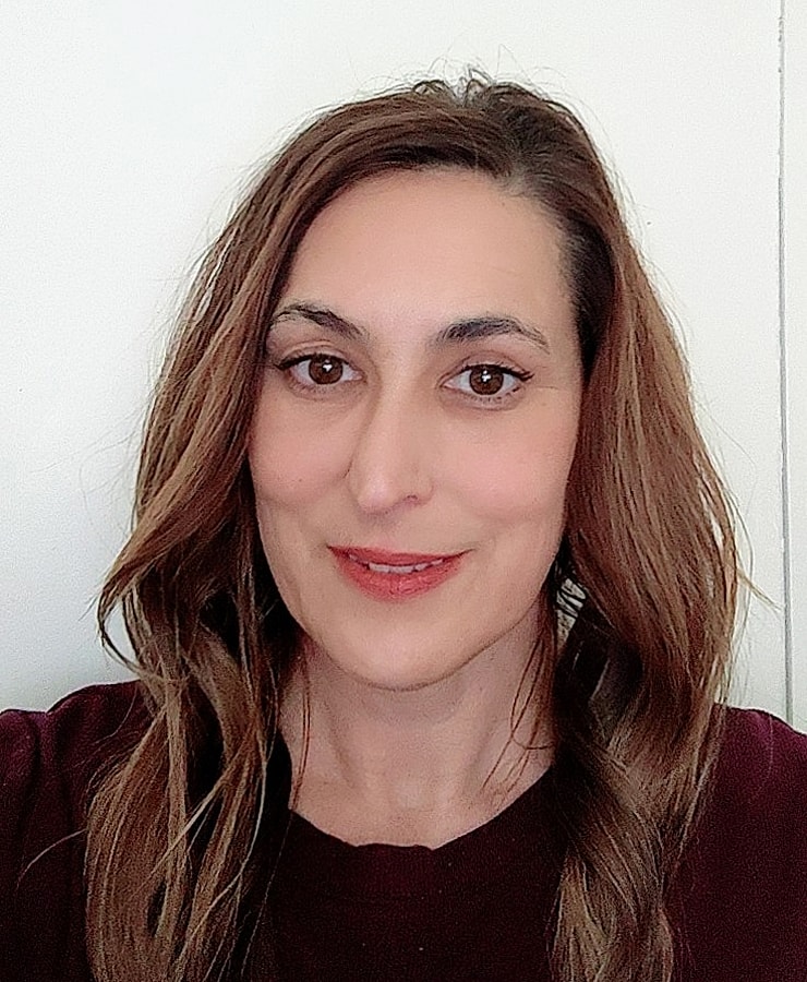 Smiling woman with long brown hair.