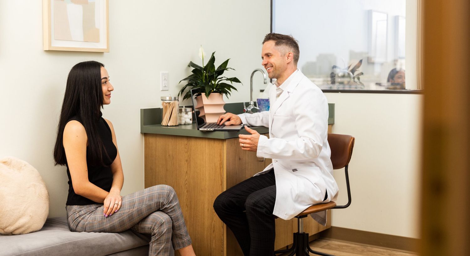 Consultation between doctor and patient in office.